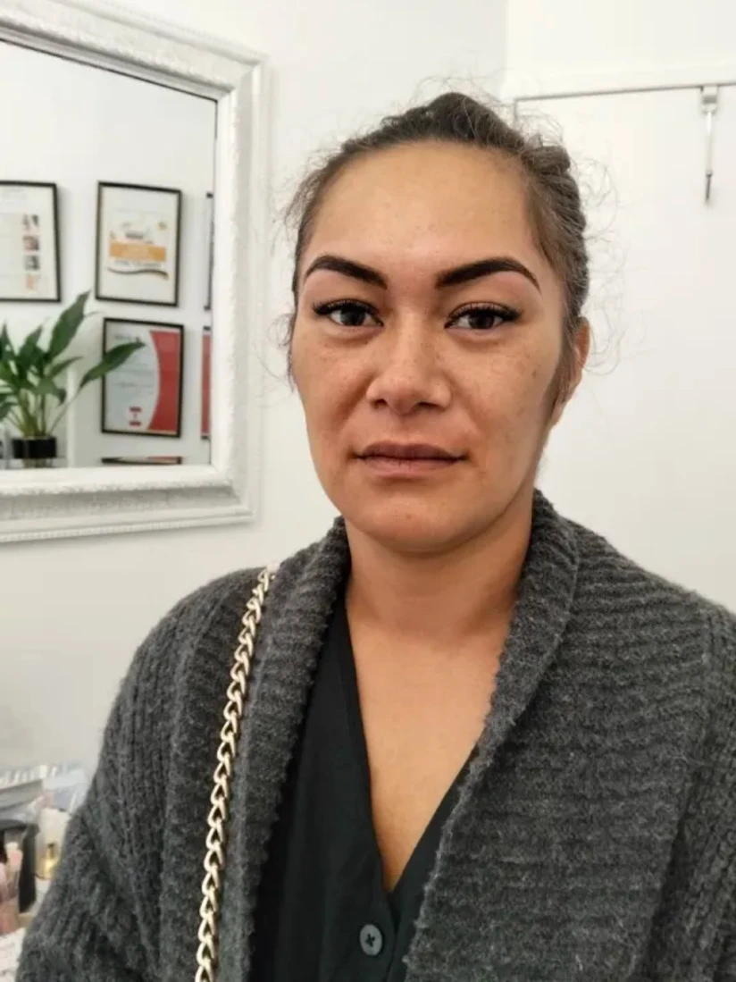 A client with her hair tied back, showing a natural-looking set of extensions and softly defined brows